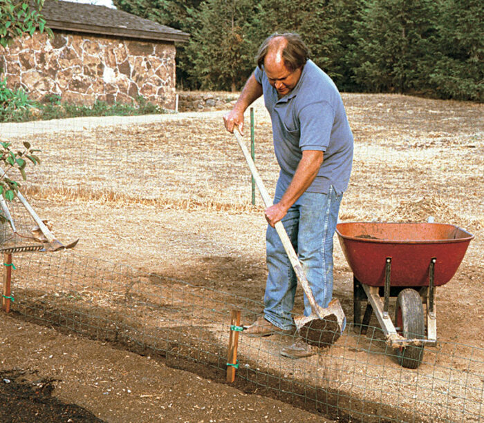 man digging soil