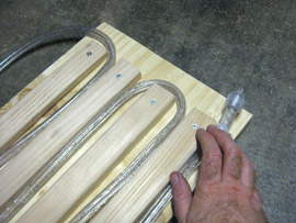 Place the closed end of the rope light at the bottom right corner of the plywood plank (if you have the long side facing you). Wrap the rope light around the 5 spaces between the furring strips