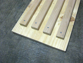 Using the 1-1/2" wood screws, attach the 4 furring strips to the plywood plank