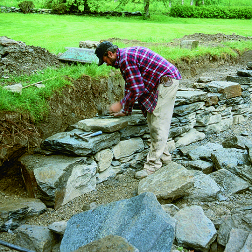 person building the retaining wall