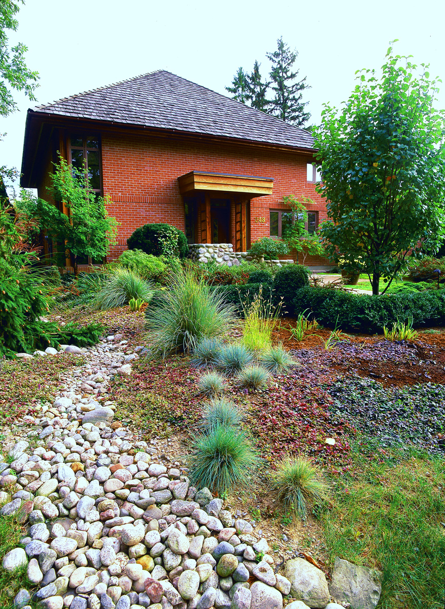 A stone river helps create another layer of interest in the garden