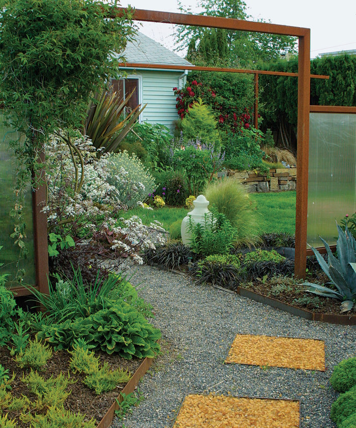 At the main entrance to author's front garden an opening in a fabricated steel fence focuses attention on the scene it frames.