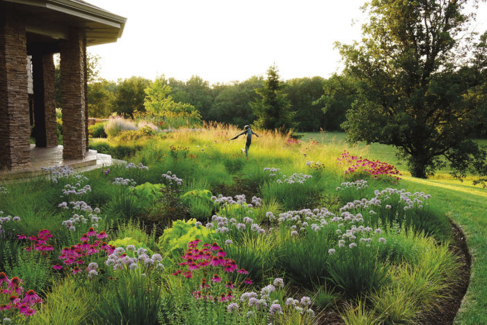 a mix of low-growing grasses and perennials with similar textures punctuated with plants with contrasting textures, colors and sizes creates a dynamic transition between the garden and the fields beyond