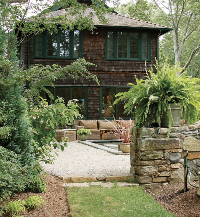 The lines of the stones in the wall and step echo those of the furniture and the house