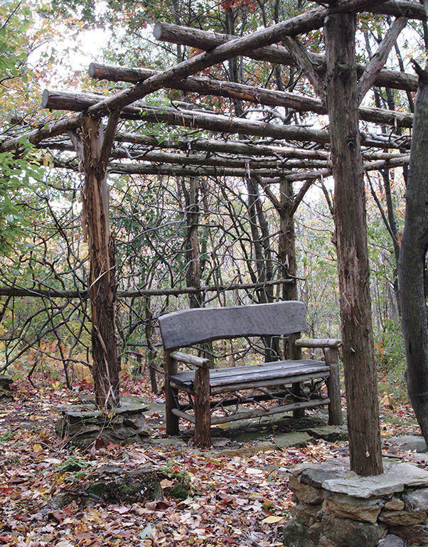 pergola over a bench in the fall