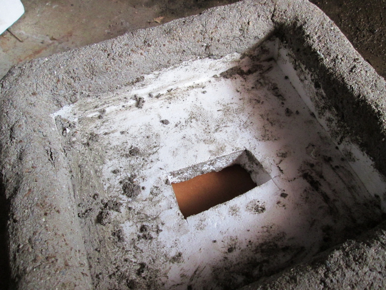 styrofoam container with drainage hole cut into it