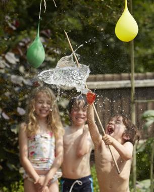 kids popping water balloons