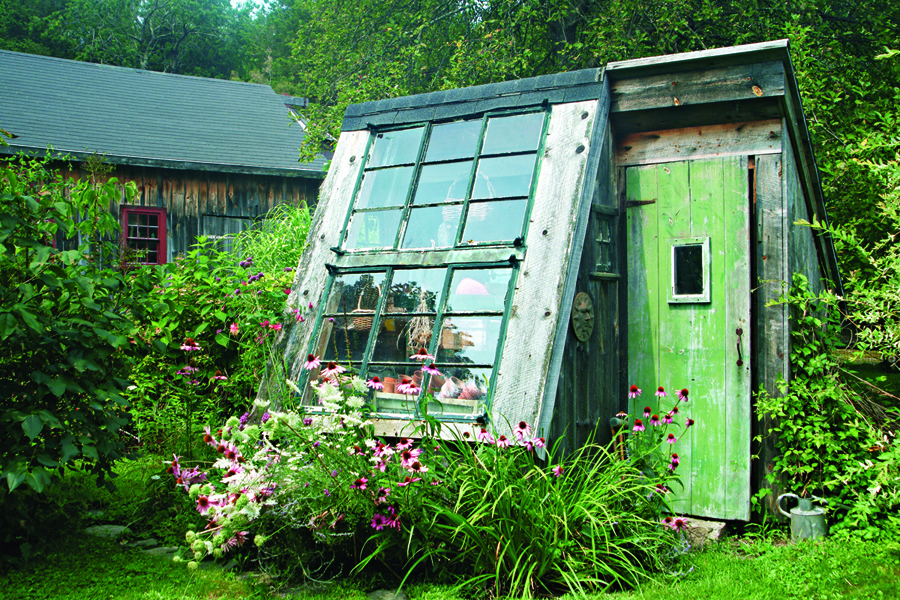 This repurposed cottage with its south-facing window serves as a rustic greenhouse