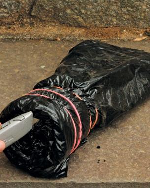 poking drainage holes with a razor into the base of the rolled up plastic bag