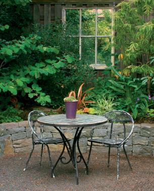 A window frame with the glass removed and a mirror put in its place reflects green space and creates the illusion of a much larger area