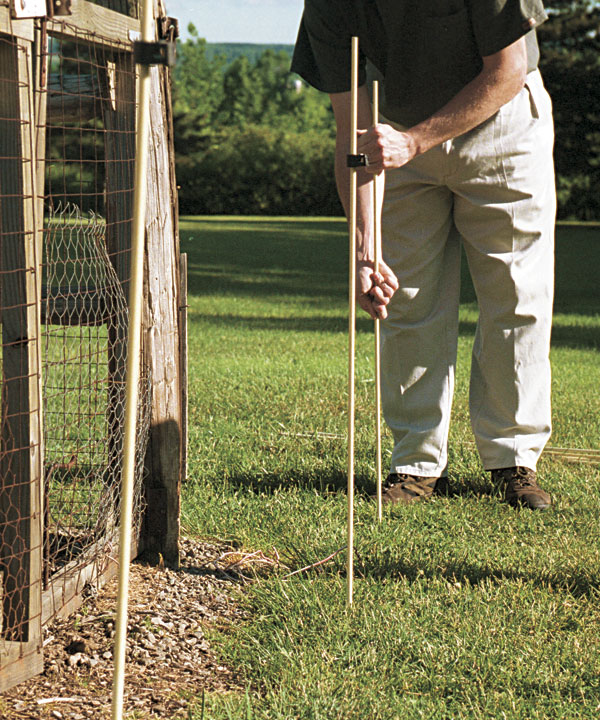 Space the fiberglass rods 8 to 12 feet apart around the garden's perimeter