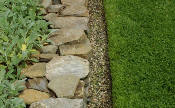 metal edging next to lawn, rocks and plants