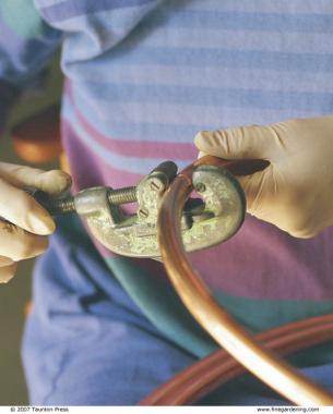 Tighten the set screw on the pipe cutter just a little at a time, or you risk crimping the pipe.