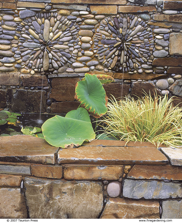 These sunburst mosaics frame the water spouts in a wall above a pool.