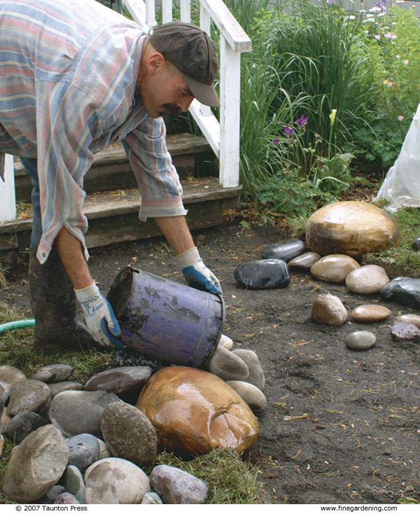 Author pouring stones onto walkway to begin layout.