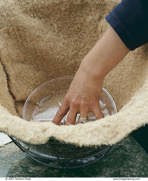 Place a wood-fiber liner in the basket with the dark side facing out. 