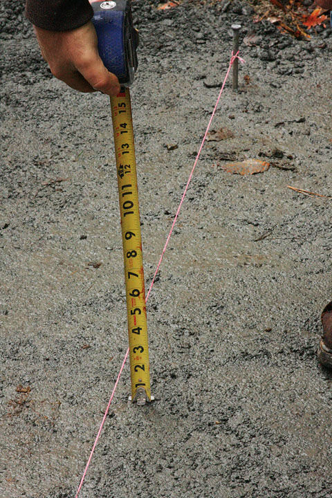 tape measuring the compacted aggregate