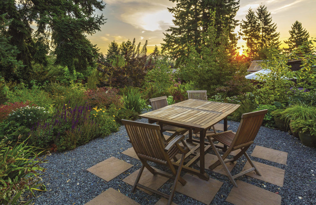 Placed atop permeable gravel patio, the table and chairs add living space.