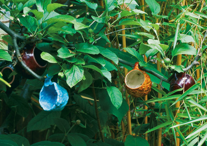 colorful coffee cups converted to dangling decorations.