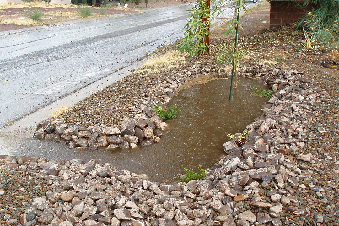 These rocks create a retention basin to redirect water from the sidewalk.