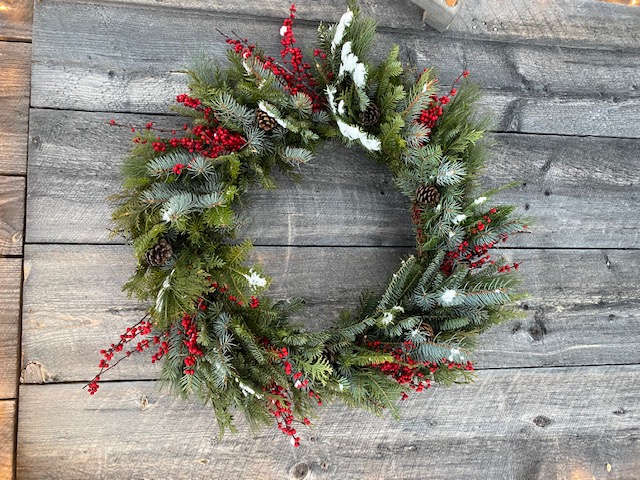 A wreath hanging on a wooden wall