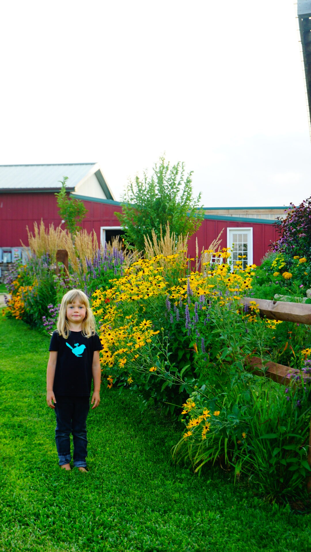 child next to flowers