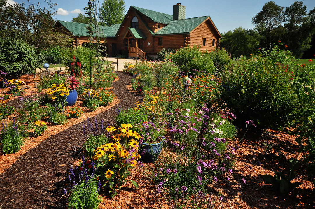 log cabin with flower garden