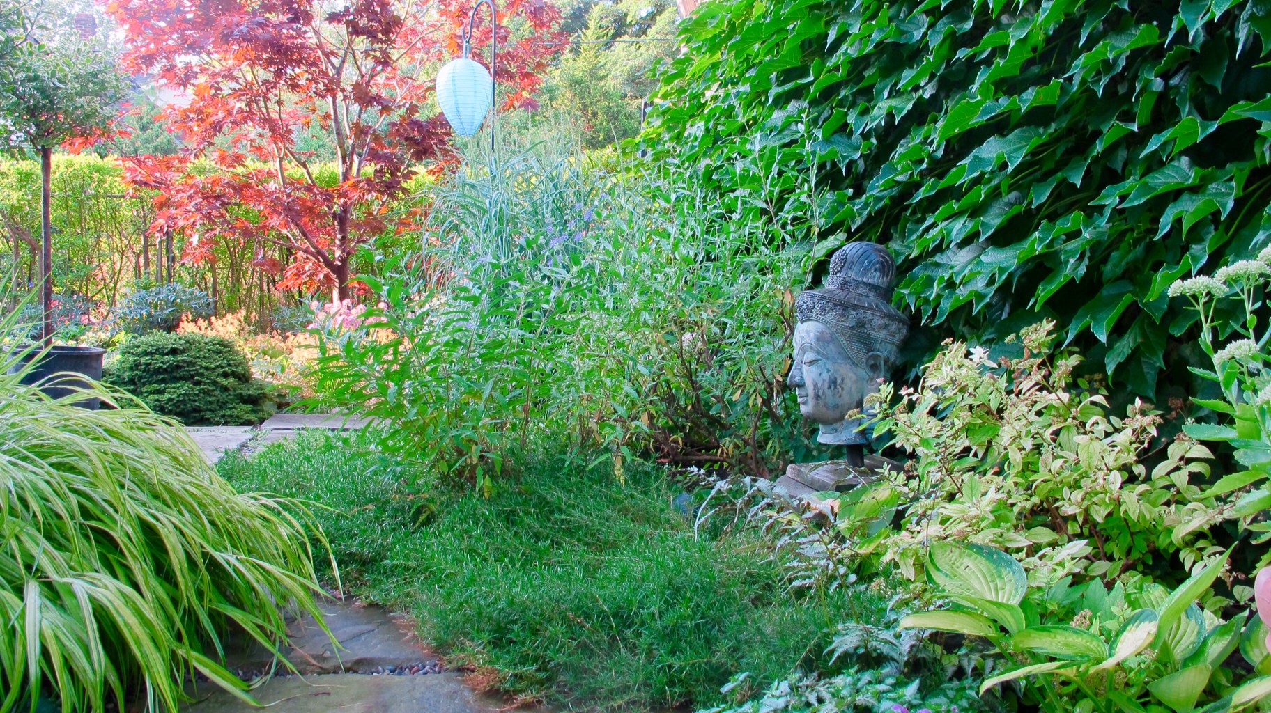 Buddha statue surrounded by greenery