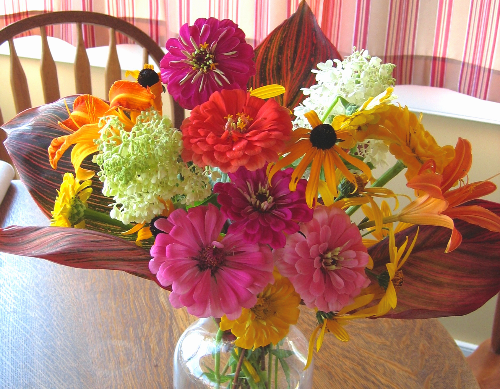 Tropicanna and Zinnias in vase