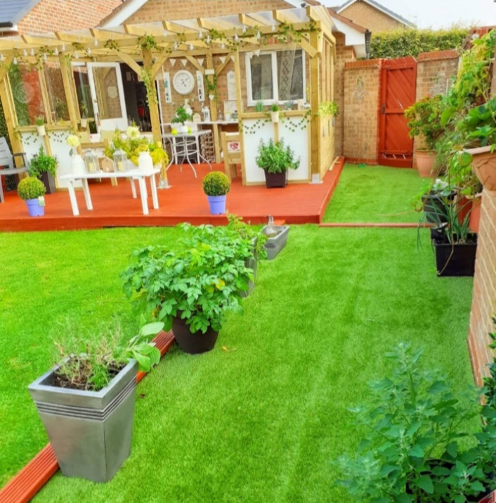 backyard garden with pergola and planters