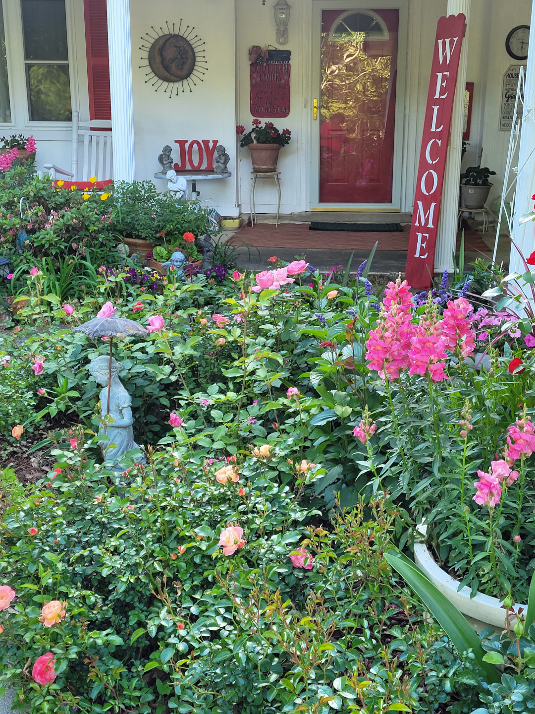 Front porch with a garden full of pink flowers