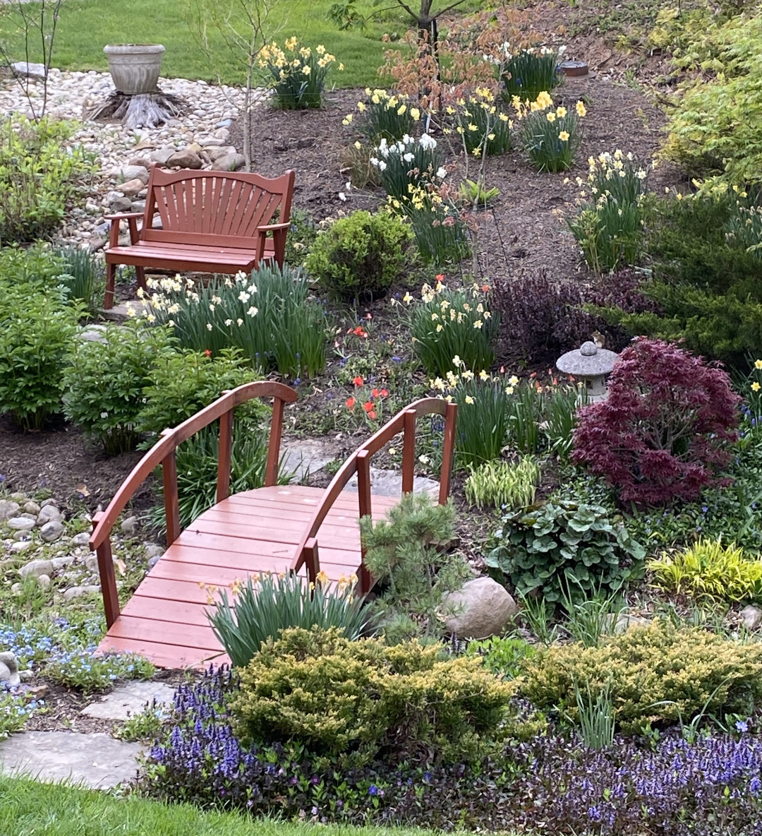 Bridge over a dried creek with gardens on both sides