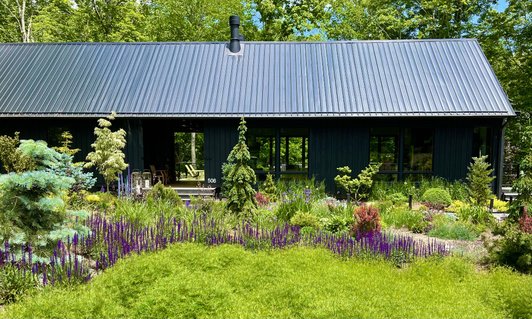 garden in front of long black house