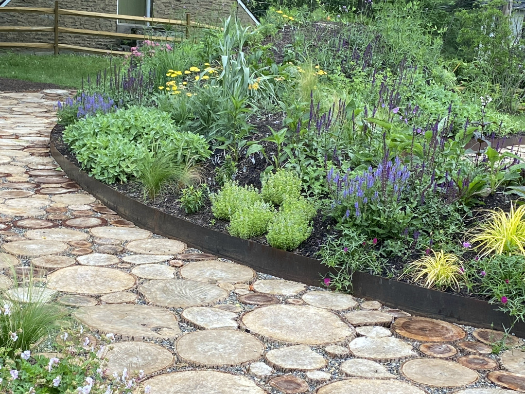 pathway next to a garden made of pieces of log slices laid flat