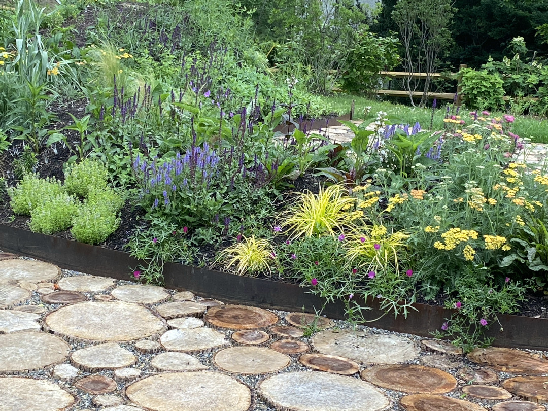 A mounded garden full of flowers and colorful foliage