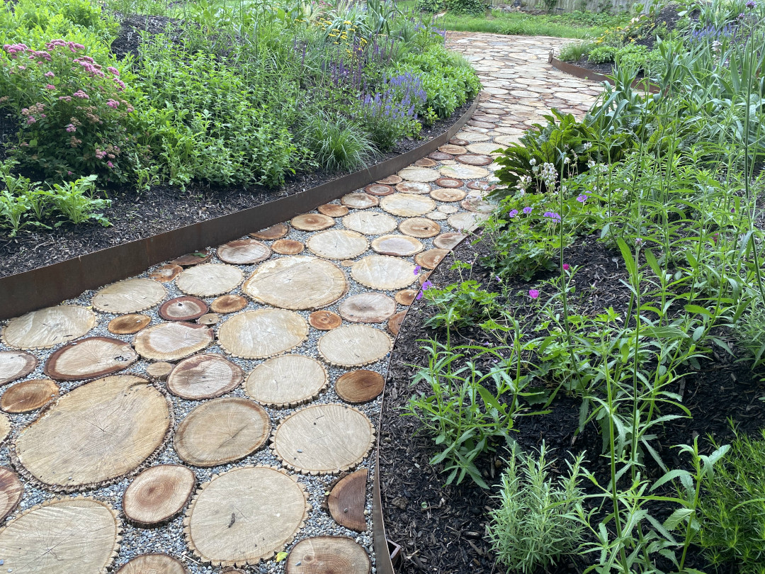 Looking down a path between two mounded garden beds