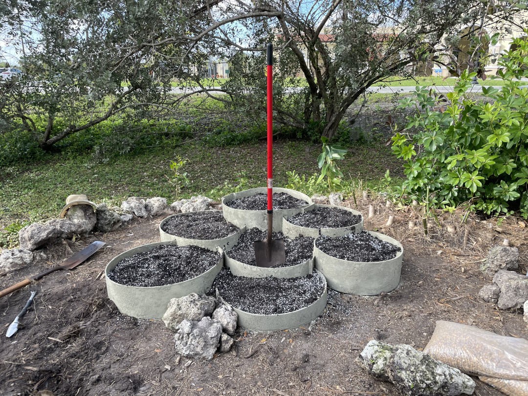 Garden bed made out of circles of different heights filled with soil