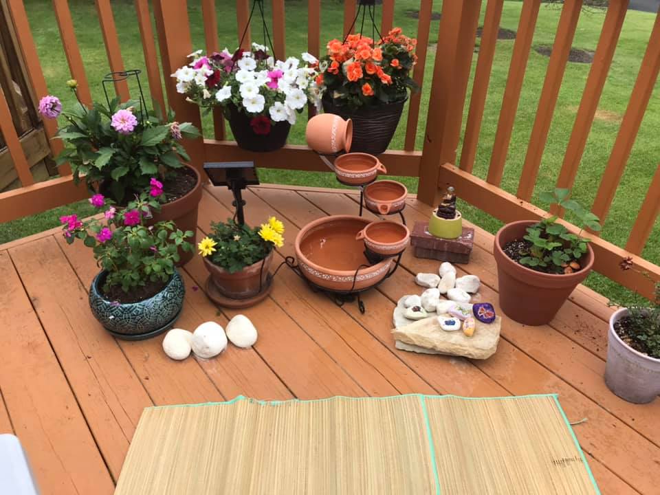 potted plants on a deck with small water feature