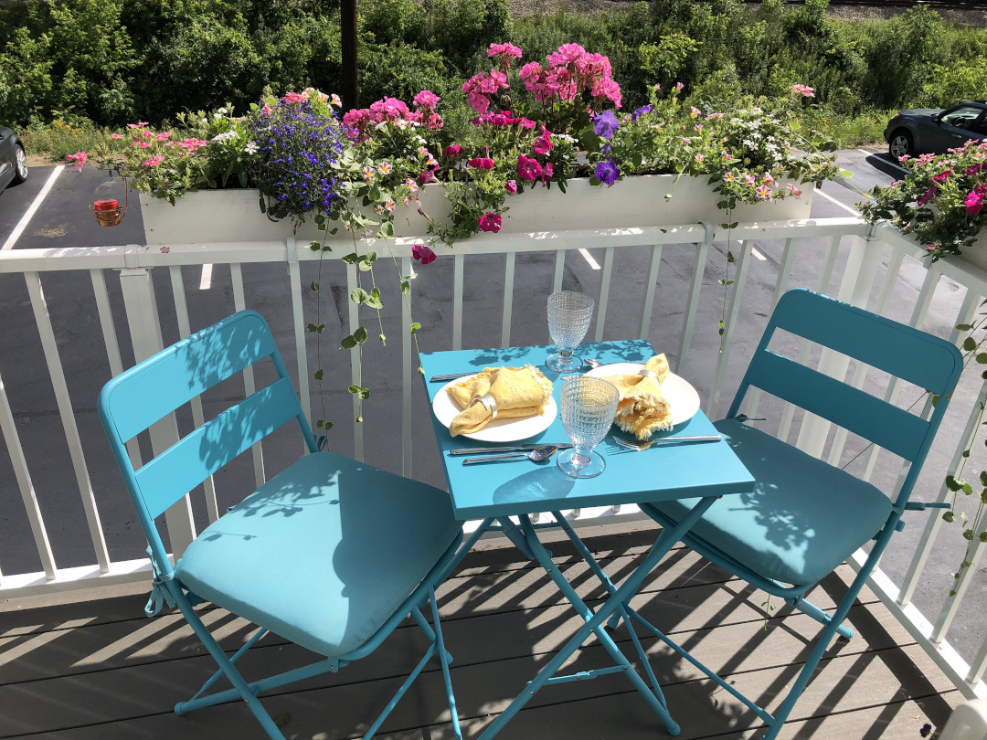 bright blue metal chairs on a porch