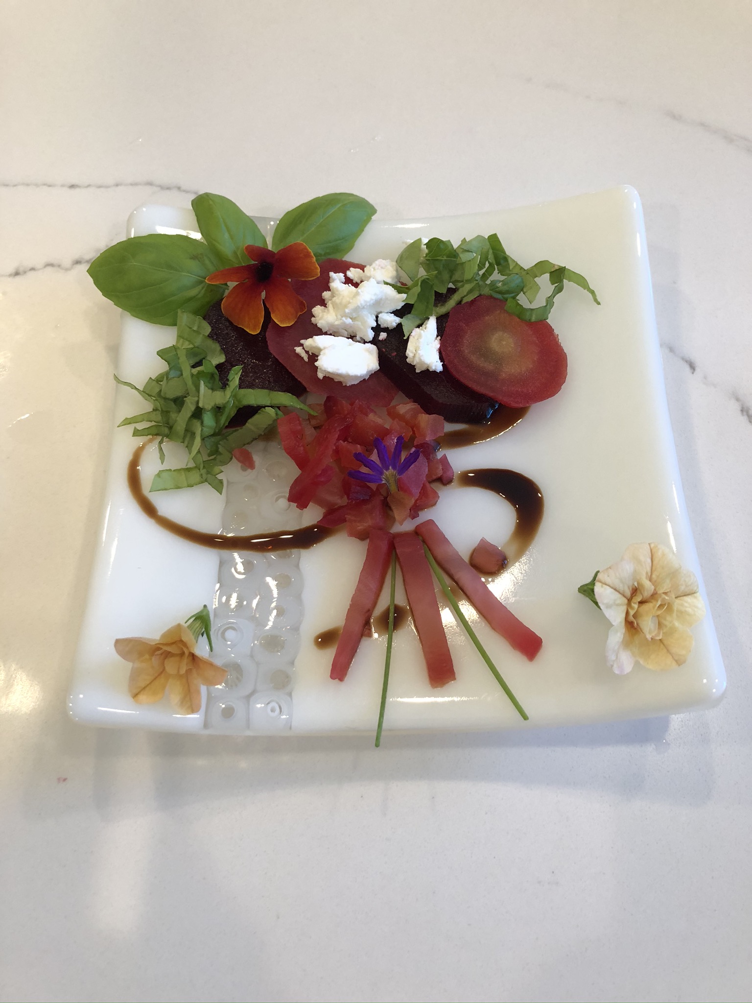 creative beet salad with basil and edible flowers