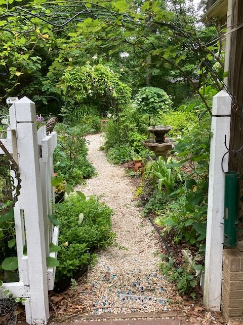 view of garden through fence gate