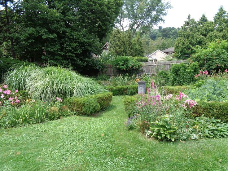 garden beds with big ornamental grass and pink flowers