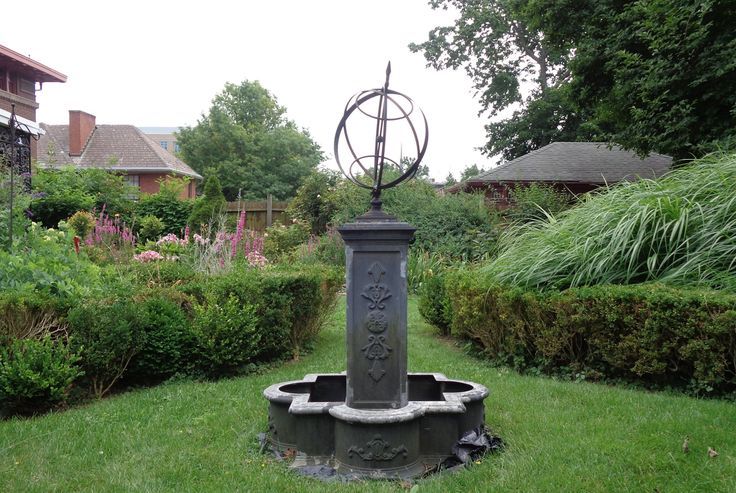 antique pedestal with garden beds on both sides