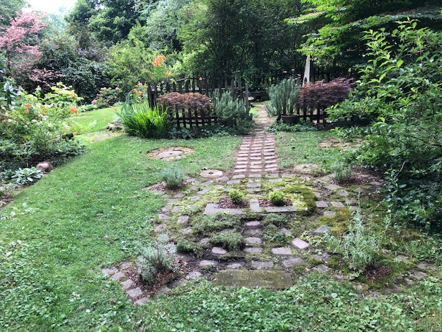 garden path leading to fenced in area