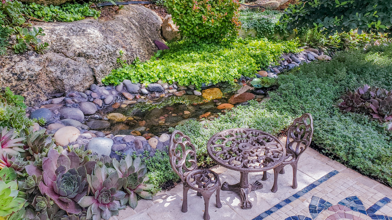 mini chairs and table next to mini pond