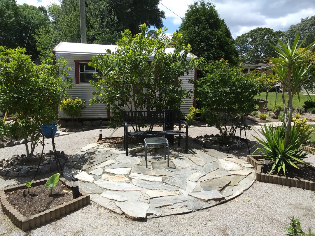 small garden patio surrounded by foliage plants