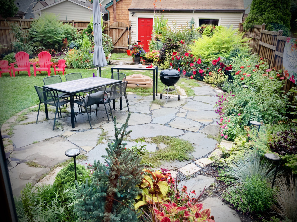 garden patio surrounded by plants and flowers