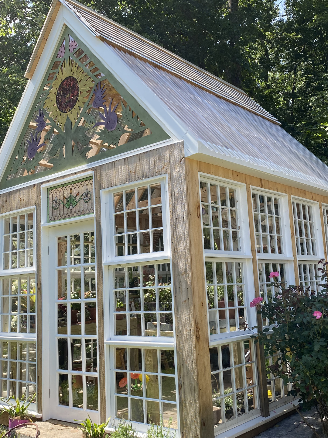 greenhouse with sunflower design on front gable