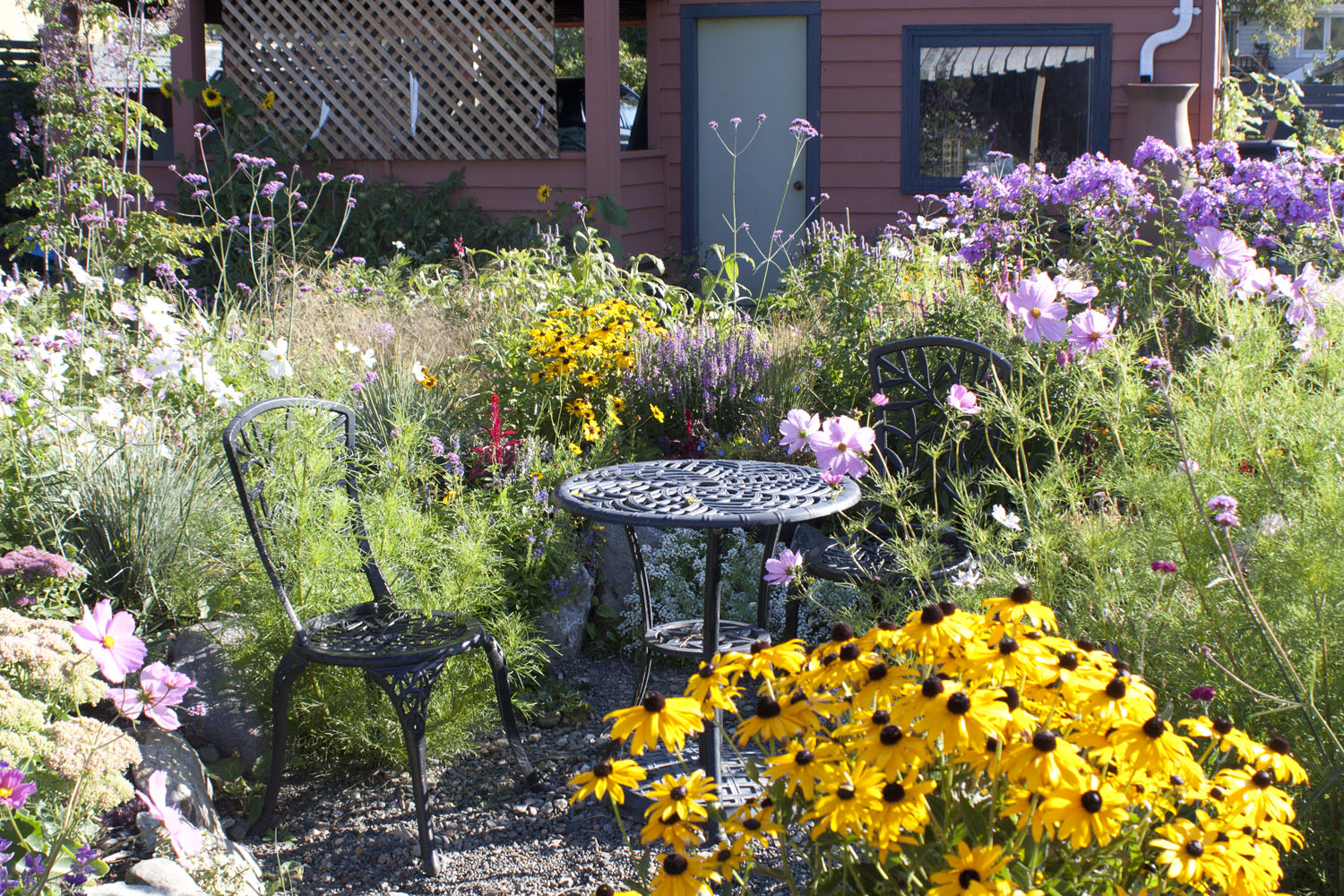 late summer flowers around a small table and chairs