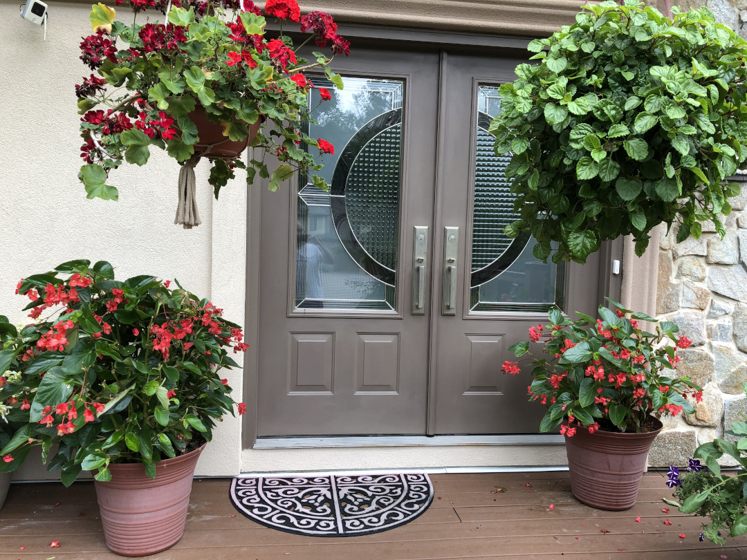 Beautiful containers frame the front door.